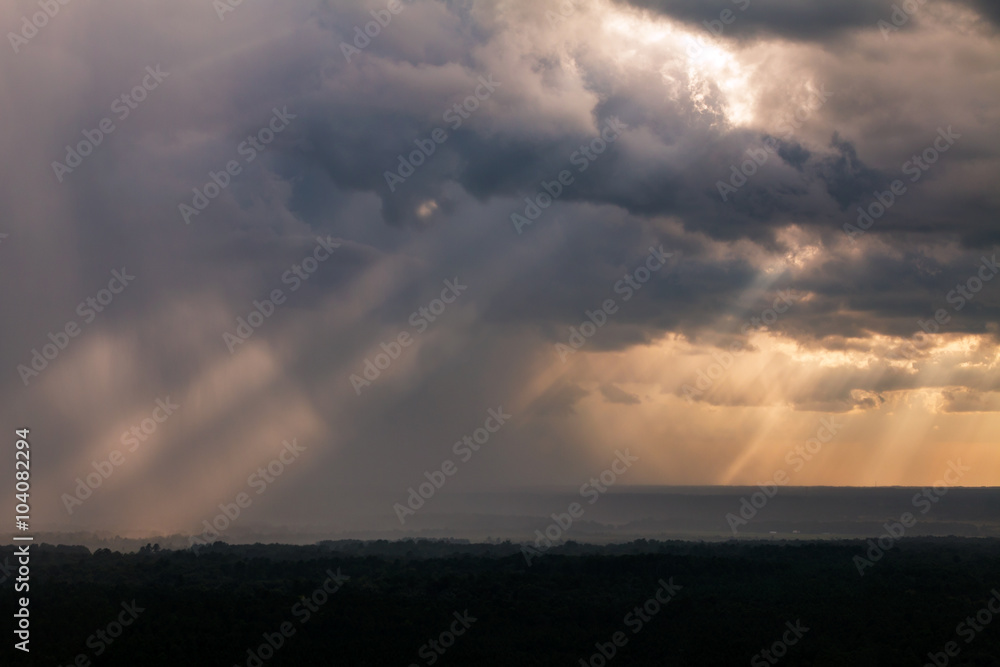 Sun rays breaking through clouds on a stormy cloudy day looking peaceful serene divine meditative calm unearthly