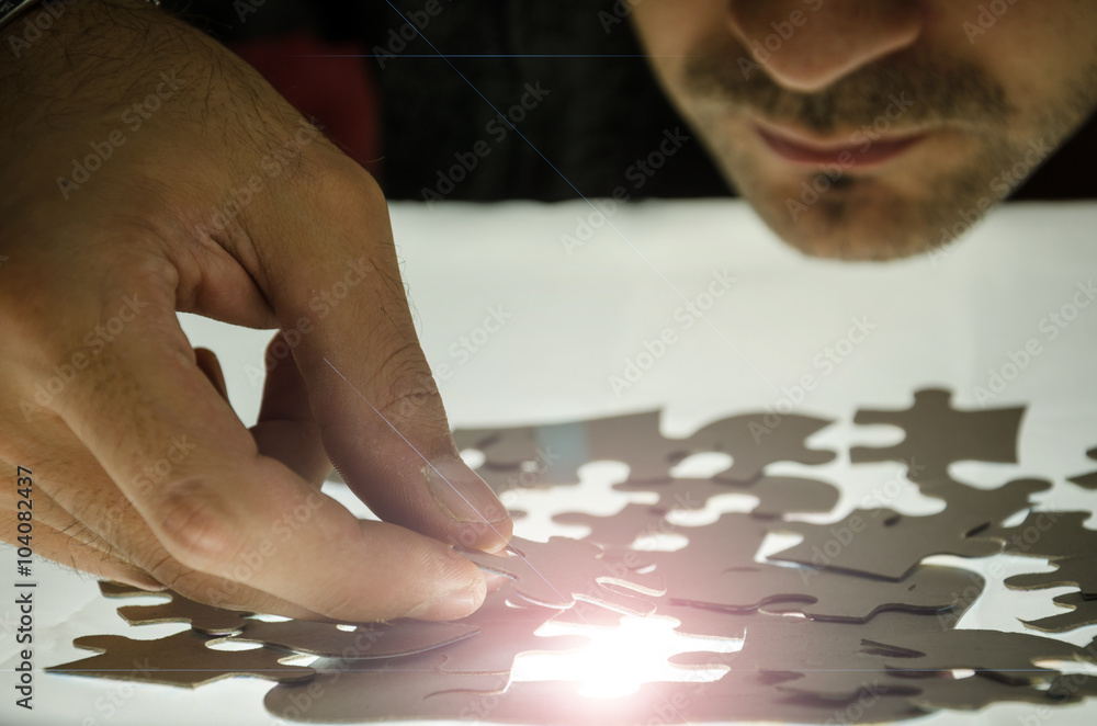 Obraz premium Man puzzle fits on a light surface