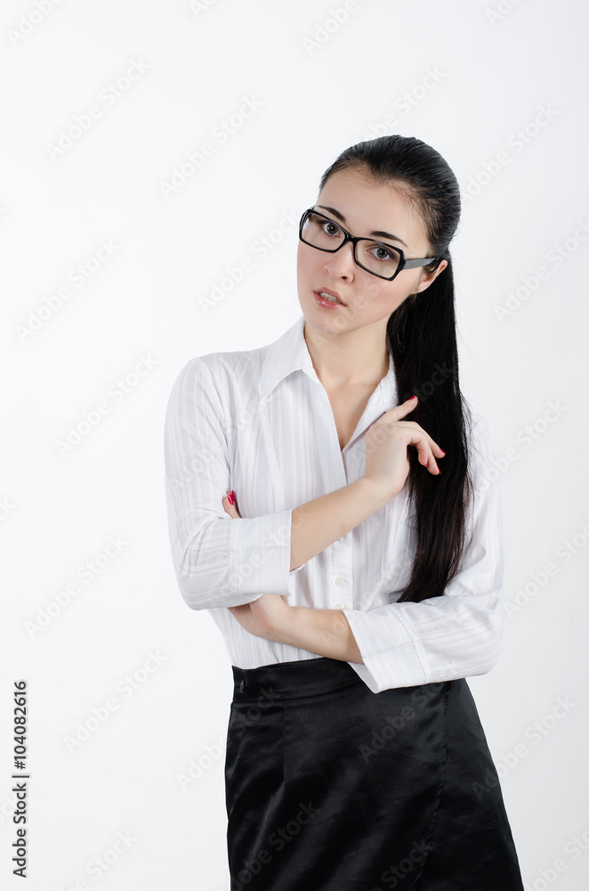 Business woman in a white shirt and black skirt and glasses with black frames. Secretary, teacher.Studio shot Business woman in a white shirt and black skirt and glasses with black frames. Secretary, teacher.Studio shot