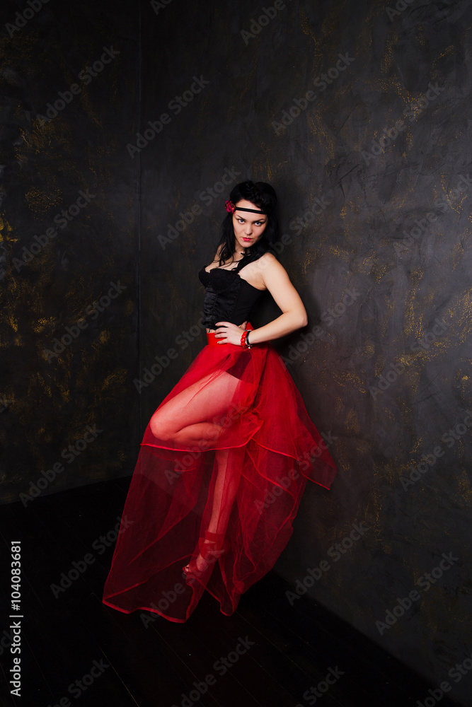 Portrait of woman wearing beautiful long red skirt and corset