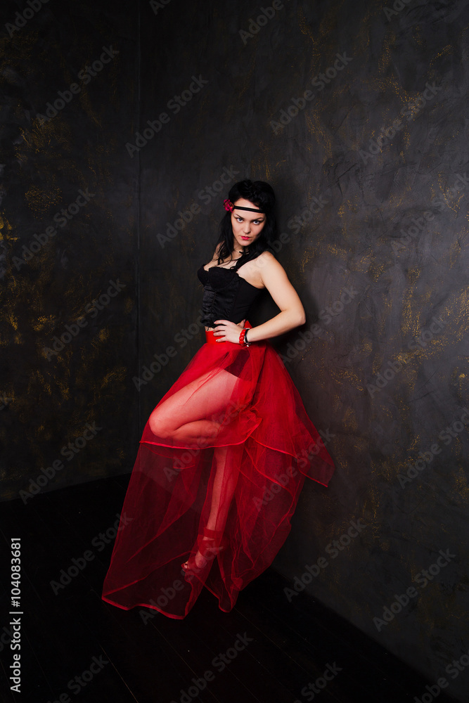 Portrait of woman wearing beautiful long red skirt and corset Portrait of woman wearing beautiful long red skirt and corset