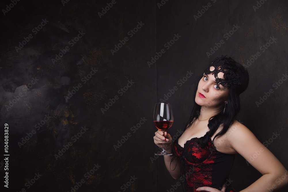 beautiful brunette woman holding a glass of red wine beautiful brunette woman holding a glass of red wine
