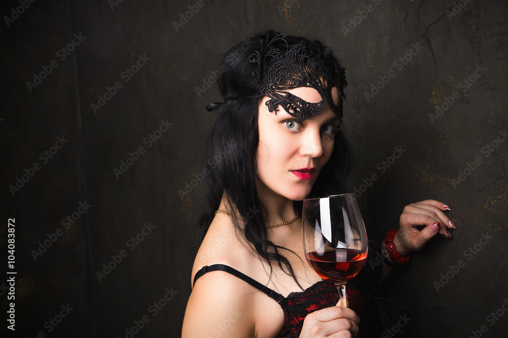 beautiful brunette woman holding a glass of red wine beautiful brunette woman holding a glass of red wine
