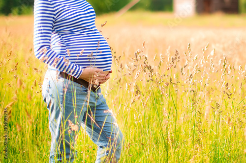 Young beautiful pregnant woman outdoors