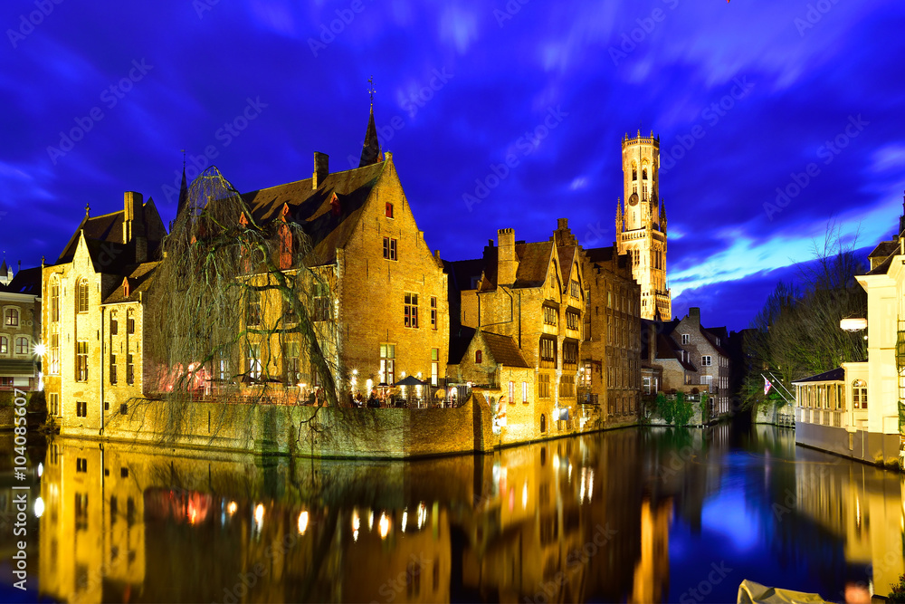 Cityscape of Brugge at dusk, illuminated architecture among the canal in Belgium