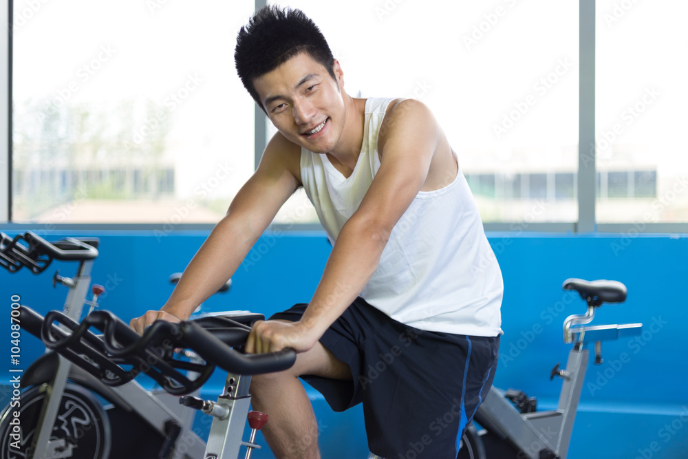 Fototapeta premium young man working out in modern gym
