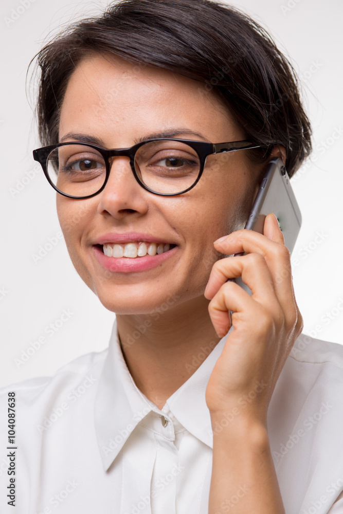 Attractive young business woman talks on her smartphone