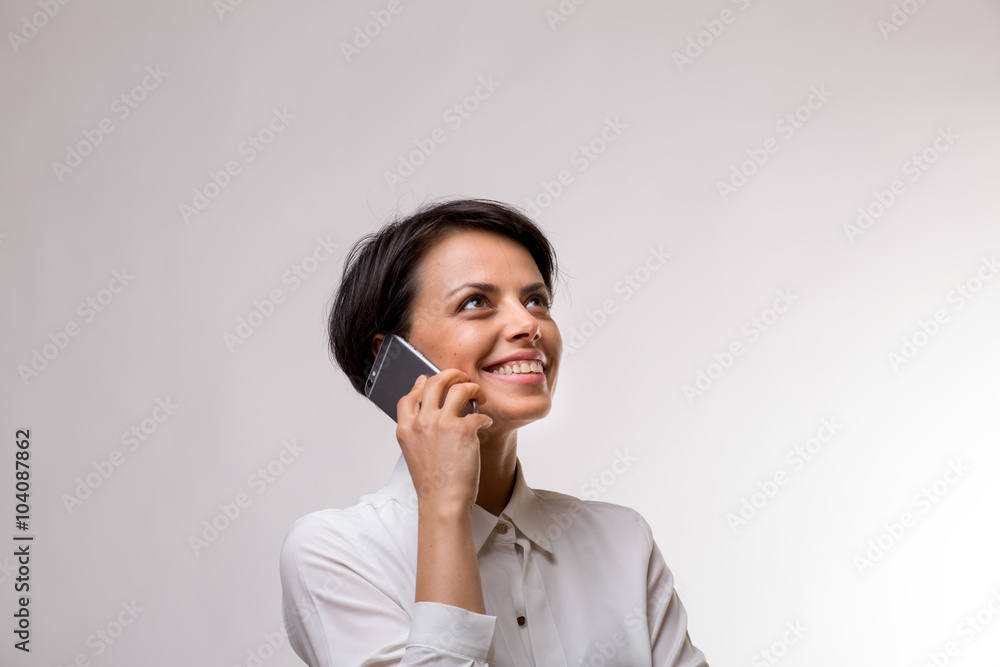 Attractive young business woman talks on her smartphone Attractive young business woman talks on her smartphone