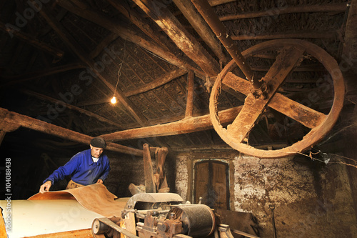 Schilderij op canvas traditional  tanner  with old tools and machinery  in the antique tannery