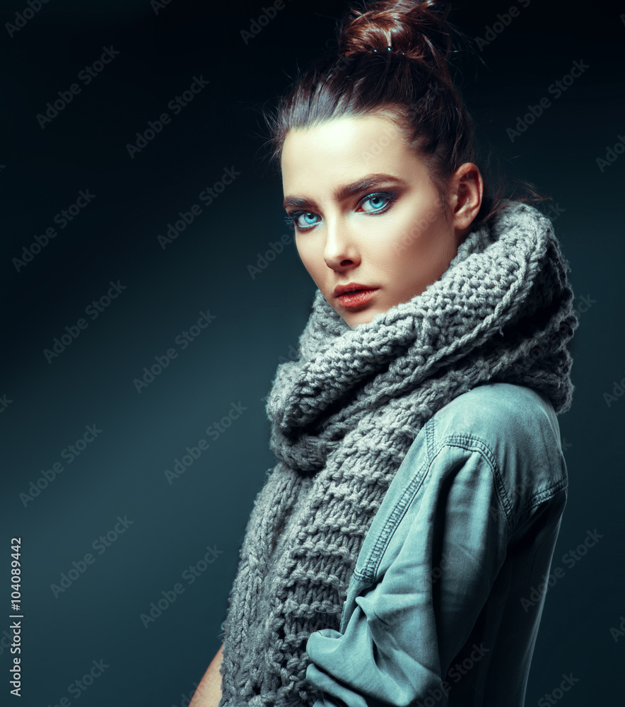 Fashion brunette model in nice clothes posing in the studio with makeup and hairstyle. Fashion brunette model in nice clothes posing in the studio with makeup and hairstyle.