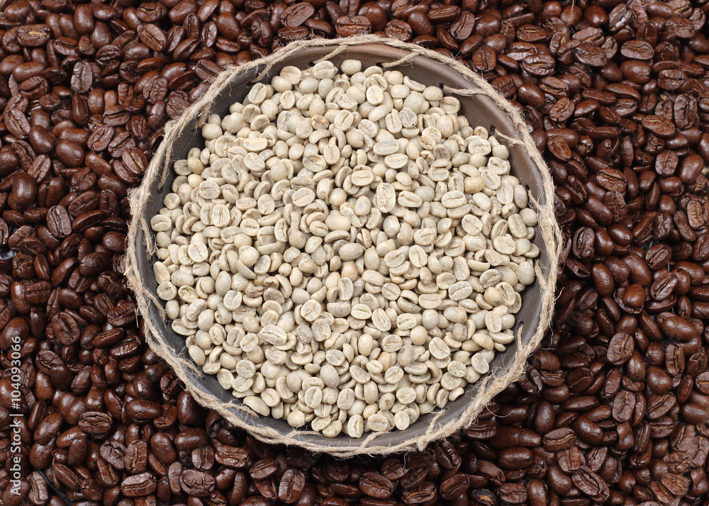 Coffee beans. Unroasted and black roasted coffee beans as background. Coffee beans. Unroasted and black roasted coffee beans as background.