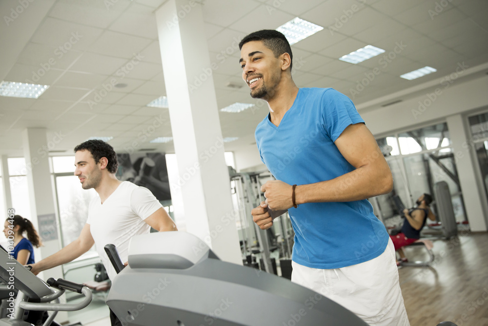 Young multiracial men in the gym Young multiracial men in the gym