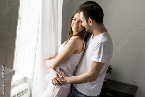 Loving couple by the window