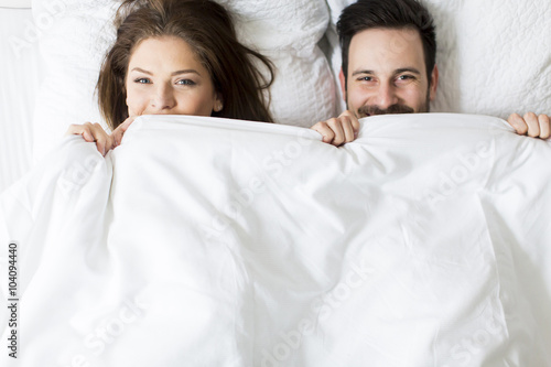 Young loving couple in the bed