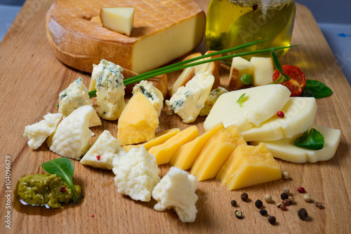 Various types of cheese laid out on a wooden Board