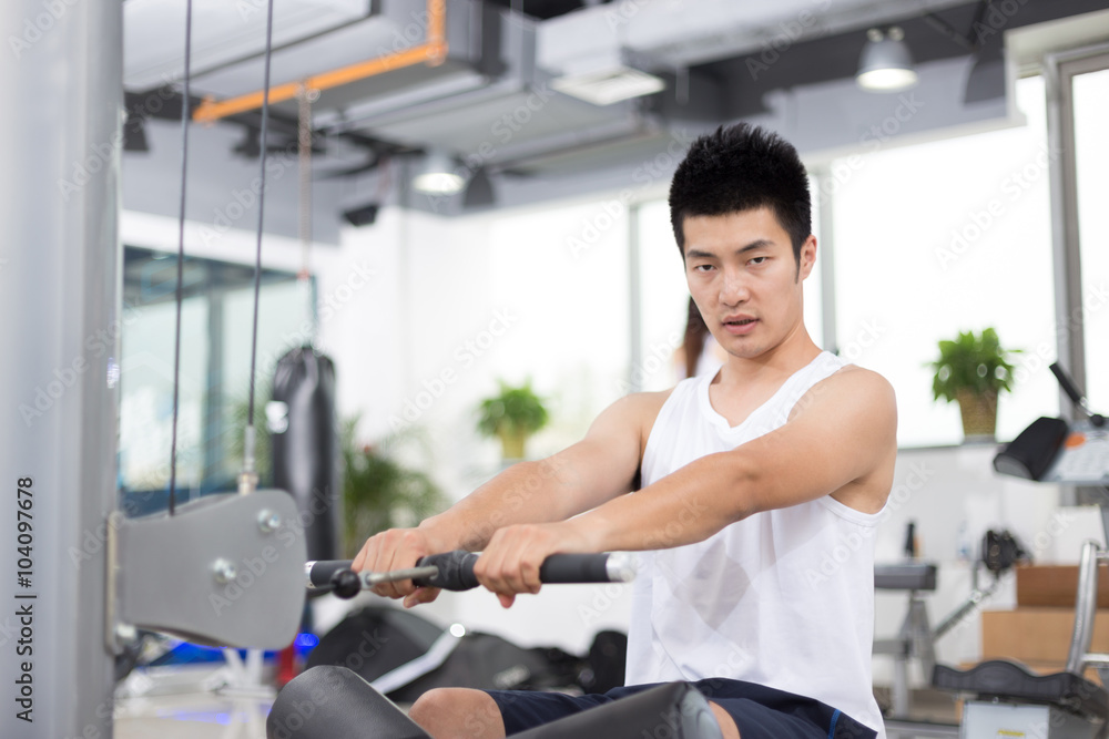 young man working out in modern gym young man working out in modern gym