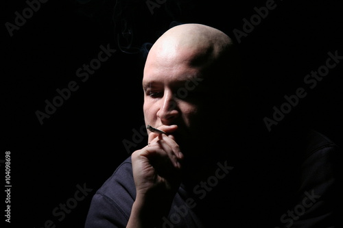 The bald man with a cigarette