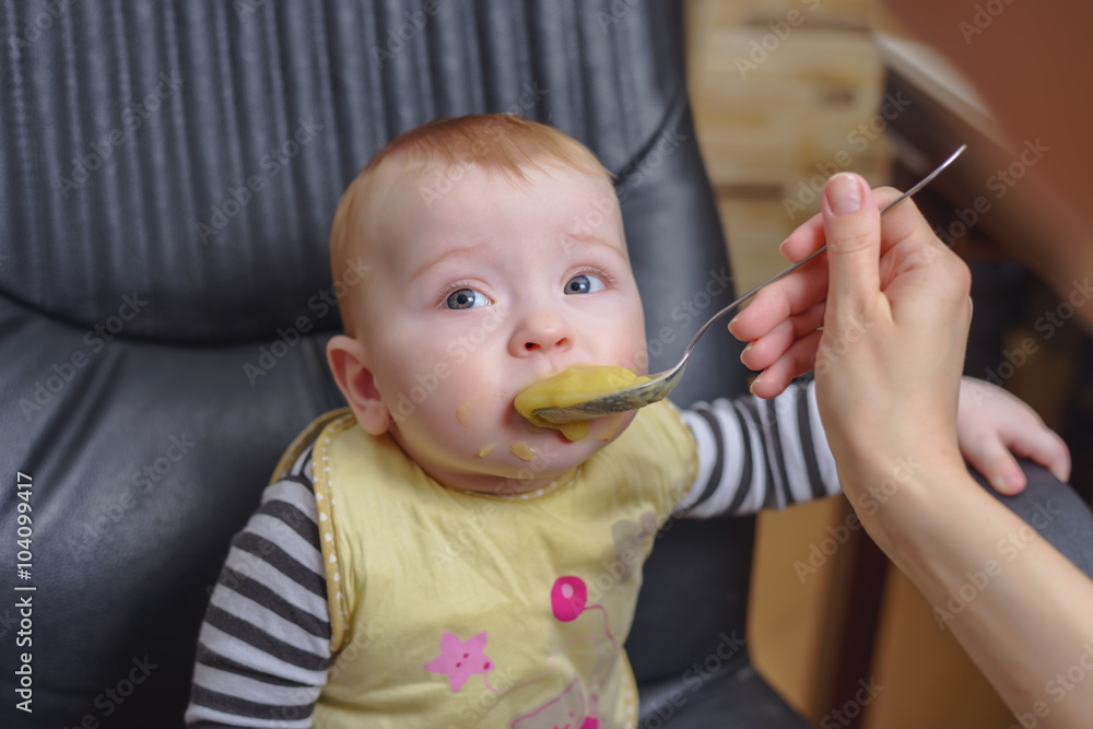 Baby Boy on Office Chair Eating Porridge Baby Boy on Office Chair Eating Porridge
