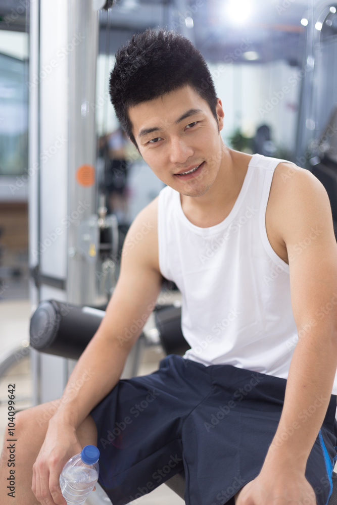 young man working out in modern gym young man working out in modern gym