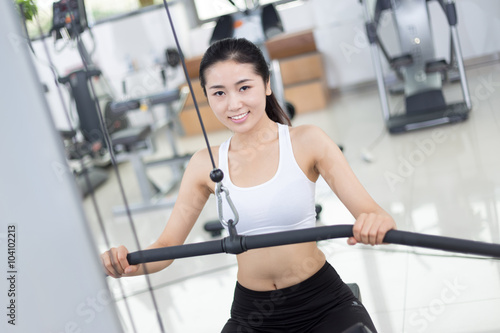 beautiful girl working out in modern gym