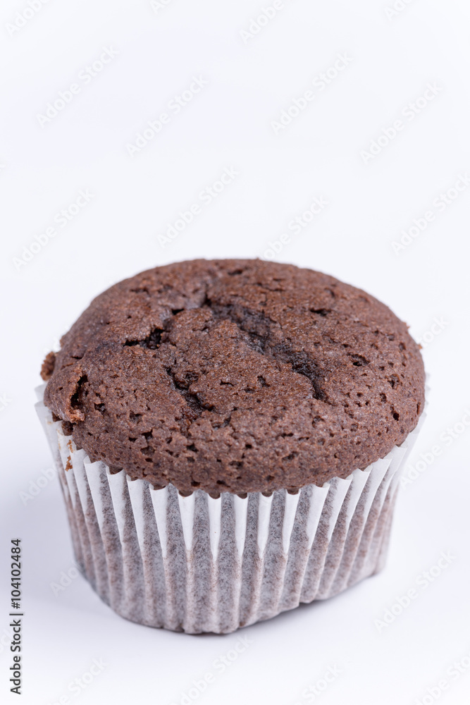 Macro view of chocolate muffin over white Macro view of chocolate muffin over white