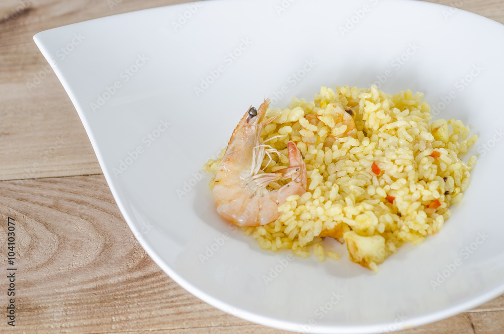 Paella, typical Spanish dish on white background. Paella, typical Spanish dish on white background.