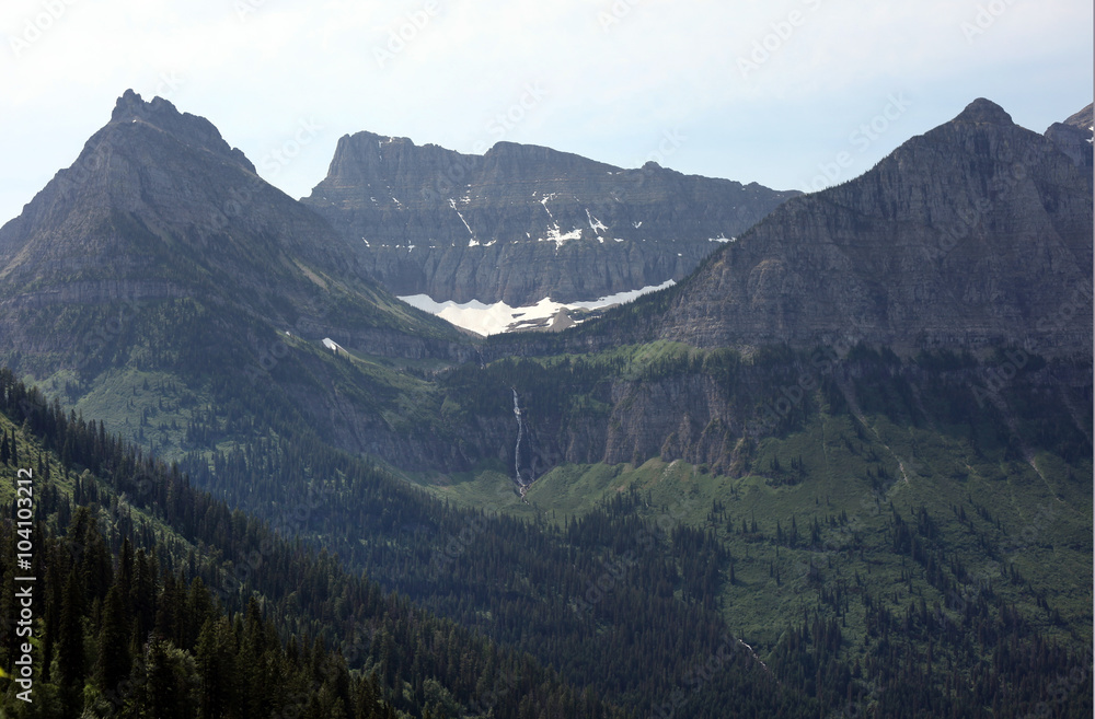 Naklejka premium The imposing rocky glacial peaks of Glacier National Park in northwest Montana straddle the U.S.-Canadian border, with the Canadian side of the park called Waterton Lakes National Park in Alberta.