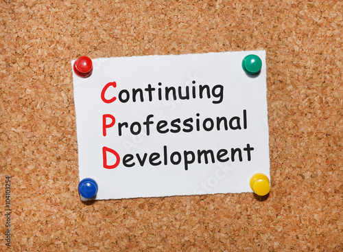 The phrase Continuing Professional Development typed on a white piece of note paper and pinned to a cork notice board