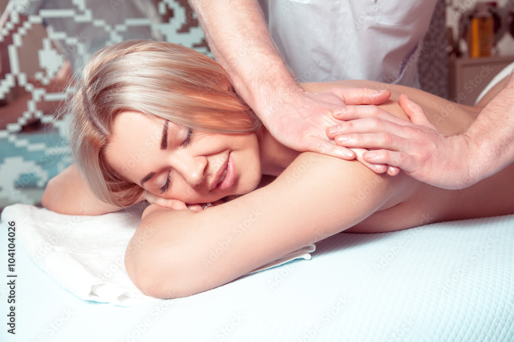 Adorable young blonde girl relaxing in spa massage salon Adorable young blonde girl relaxing in spa massage salon