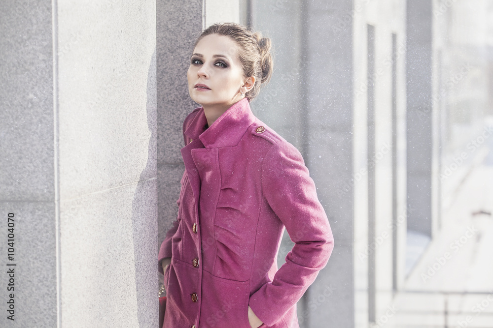 Model a beautiful woman in a fashionable coat at the background Model a beautiful woman in a fashionable coat at the background