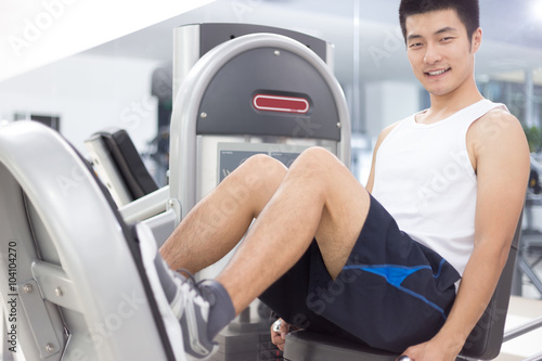 young man working out in modern gym