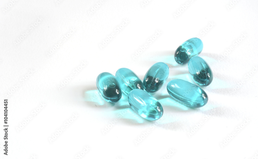 colorful capsules and pills closeup on white colorful capsules and pills closeup on white
