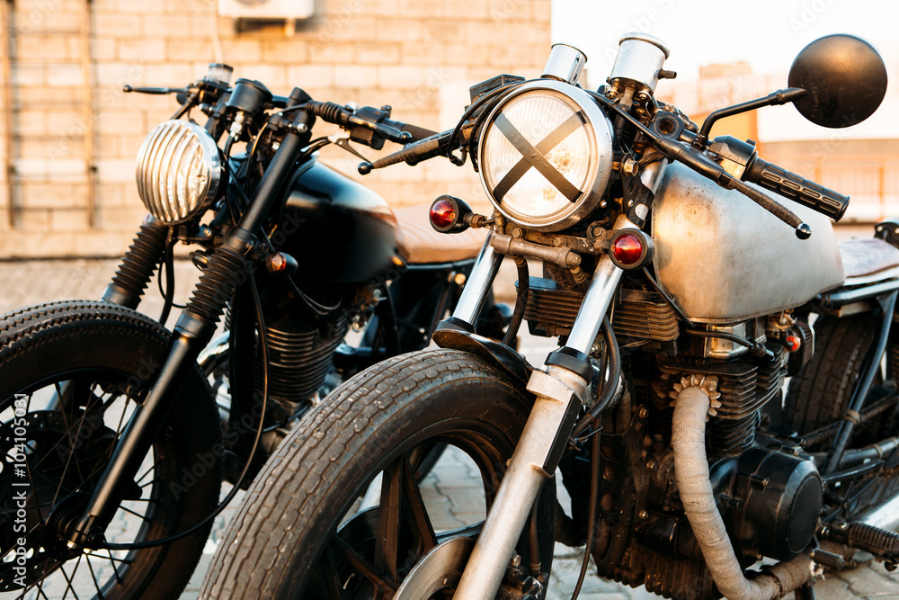 Obraz premium Two black and silver vintage custom motorcycles cafe racers