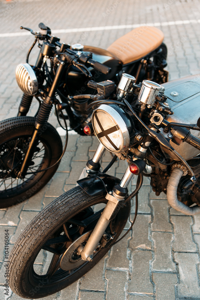 Obraz premium Two black and silver vintage custom motorcycles cafe racers