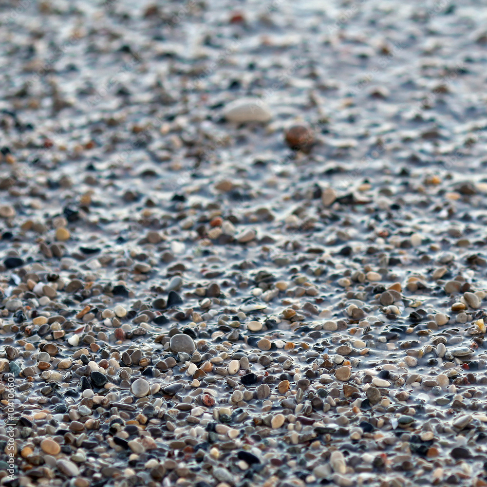 Wet beach pebbles background square Wet beach pebbles background square