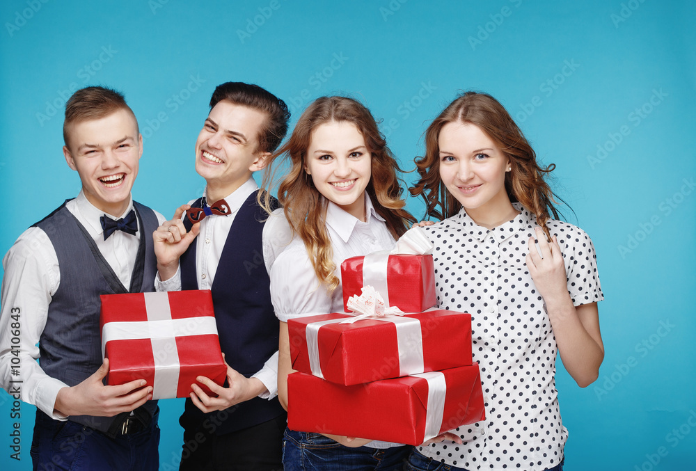 Smiling hipster group with the gifts in the studio Smiling hipster group with the gifts in the studio
