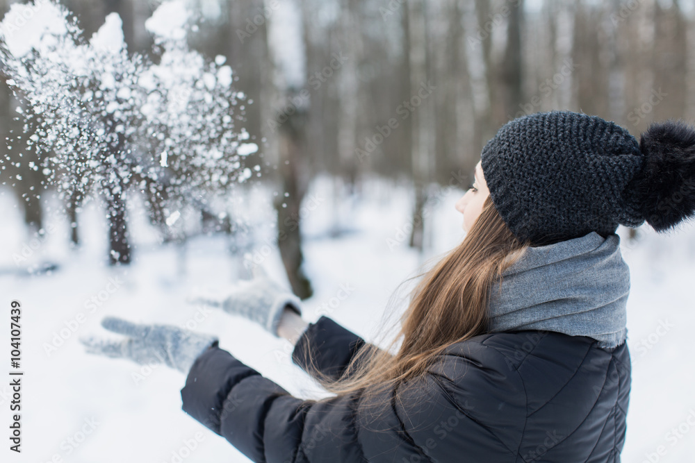 woman throwing snow in the air on winter holidays