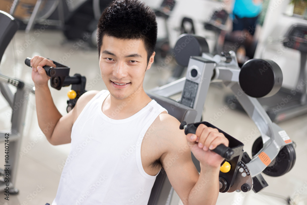young man working out in modern gym young man working out in modern gym