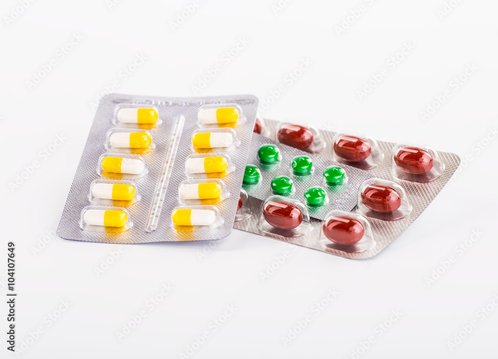 Various cold prescription bottles and a syringe isolated on a wh Various cold prescription bottles and a syringe isolated on a wh