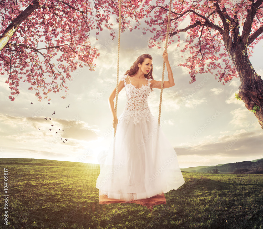 Beautiful Bride swing in the spring meadow Beautiful Bride swing in the spring meadow