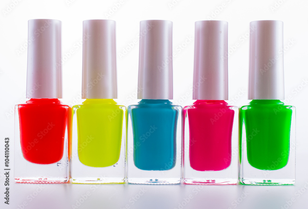 colored paints on a white background. Manicure pink, blue, red, green colored paints on a white background. Manicure pink, blue, red, green