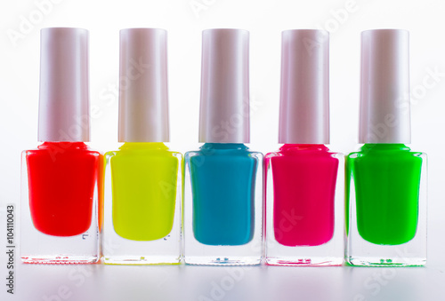 colored paints on a white background. Manicure pink, blue, red, green