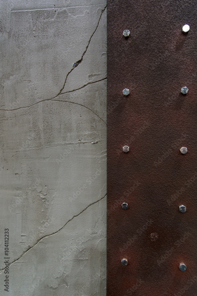 Rust corroded surface metal plate on crack wall peeling paint.