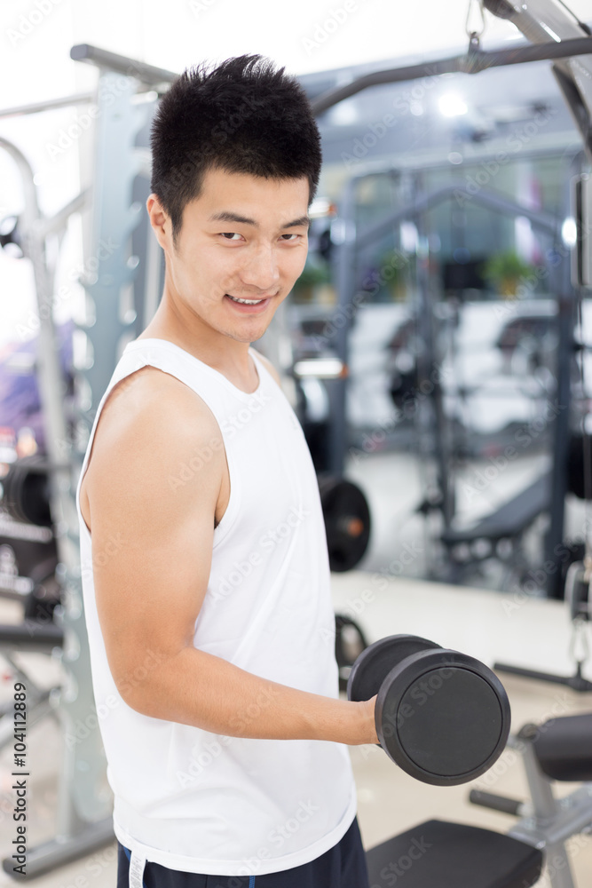 yound man working out in mdoern gym yound man working out in mdoern gym