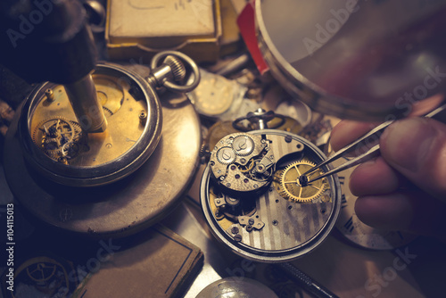 Watchmakers Craftmanship. A watch maker repairing a vintage automatic watch. photo