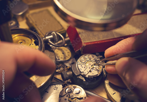 Watchmakers Craftmanship. A watch maker repairing a vintage automatic watch. photo