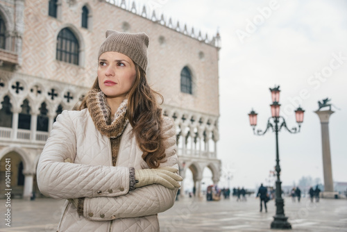 Woman tourist standing on St. Mark's Square near Dogi Palace