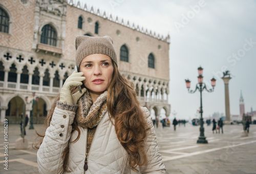 Woman tourist talking mobile phone on St. Mark's Square, Venice