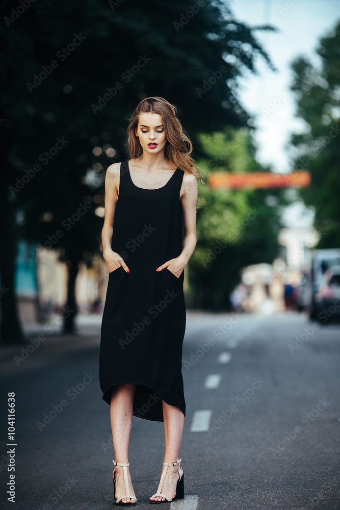pretty girl posing in a city street
