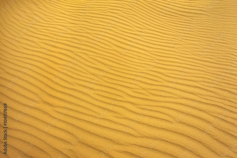 gold pattern of sand on the beach in summer. wave of sand gold pattern of sand on the beach in summer. wave of sand